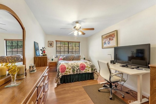 bedroom featuring multiple windows, ceiling fan, and light hardwood / wood-style floors