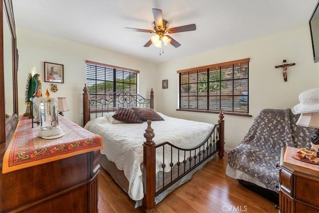 bedroom with ceiling fan and hardwood / wood-style floors