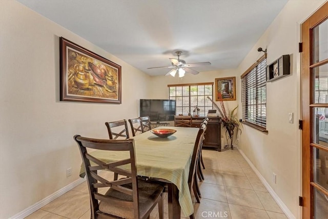 tiled dining room featuring ceiling fan