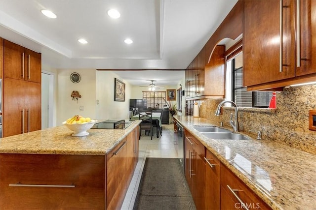 kitchen with light stone counters, sink, decorative backsplash, and black electric cooktop