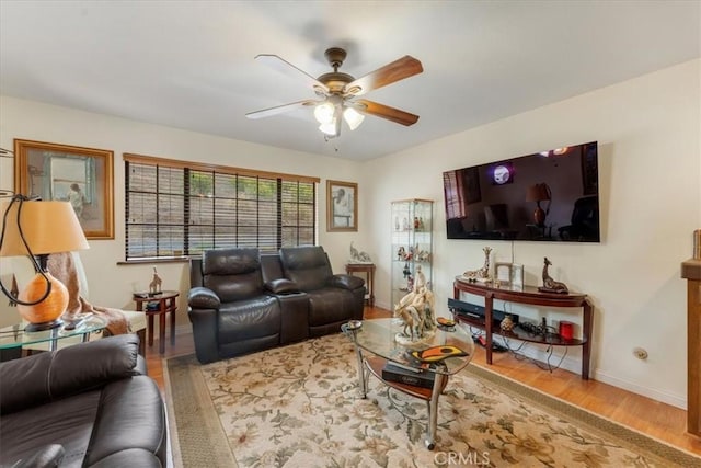 living room featuring hardwood / wood-style floors and ceiling fan