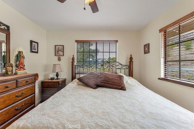 bedroom featuring multiple windows and ceiling fan