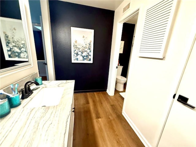1430 E Foothill Blvd, Glendora, CA 91741 - bathroom with toilet, vanity, wood finished floors, baseboards, and visible vents