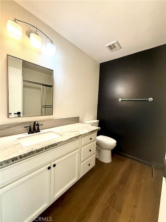 1430 E Foothill Blvd, Glendora, CA 91741 - bathroom featuring vanity, toilet, visible vents, a shower with shower door, and wood finished floors