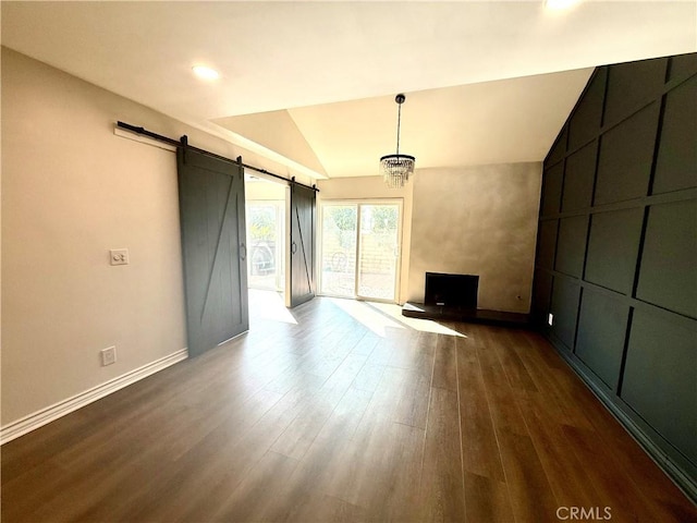 1430 E Foothill Blvd, Glendora, CA 91741 - unfurnished living room featuring baseboards, lofted ceiling, a barn door, and dark wood-style flooring