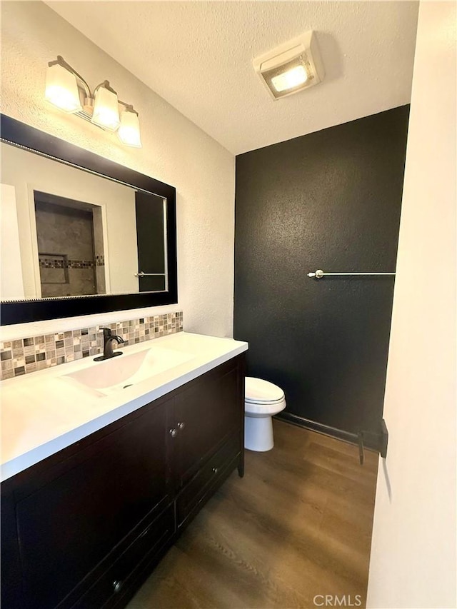1430 E Foothill Blvd, Glendora, CA 91741 - bathroom with vanity, tasteful backsplash, toilet, a textured ceiling, and wood finished floors