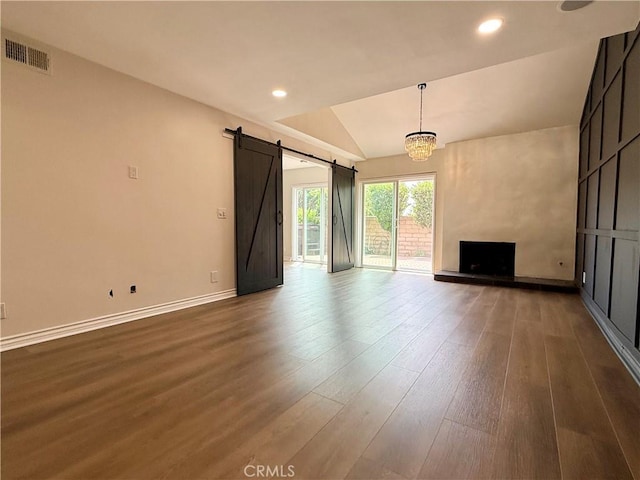 1430 E Foothill Blvd, Glendora, CA 91741 - unfurnished living room with wood finished floors, a barn door, lofted ceiling, recessed lighting, and a chandelier