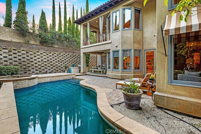 view of swimming pool featuring a patio, ceiling fan, and an in ground hot tub