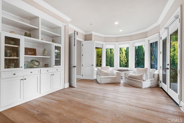 unfurnished room featuring ornamental molding and light wood-type flooring