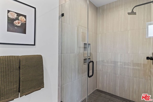 bathroom with a shower with door