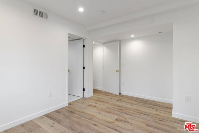 unfurnished room with light wood-type flooring