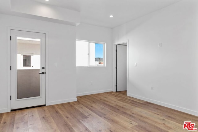 unfurnished room with light wood-type flooring