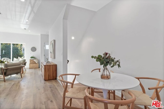 dining space with light hardwood / wood-style floors