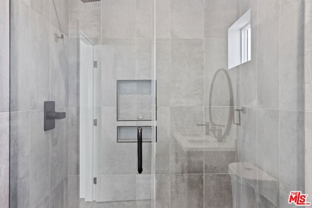 bathroom with a shower with shower door