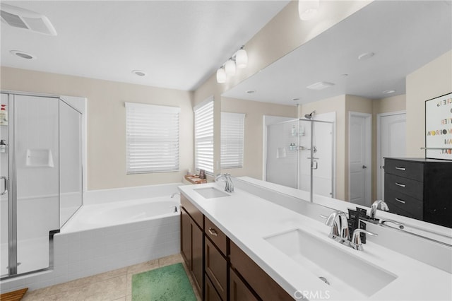 bathroom with tile patterned flooring, plus walk in shower, and vanity