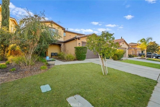 mediterranean / spanish-style house featuring a garage and a front lawn