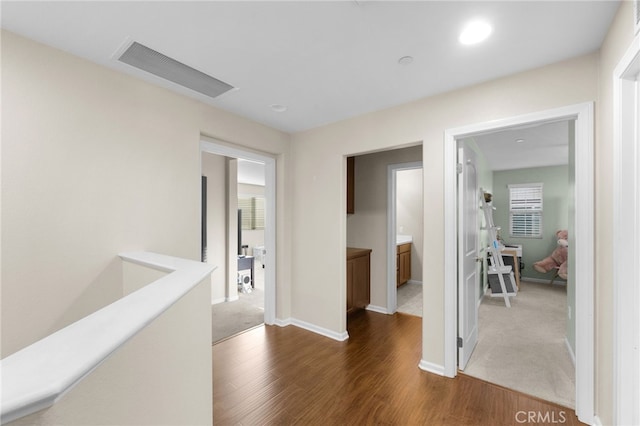 corridor featuring dark hardwood / wood-style flooring