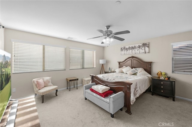 bedroom featuring ceiling fan and light carpet