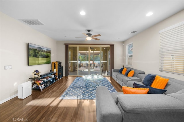 living room featuring ceiling fan and dark hardwood / wood-style floors