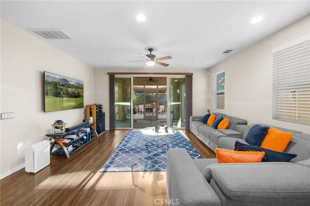 living room featuring dark hardwood / wood-style floors and ceiling fan