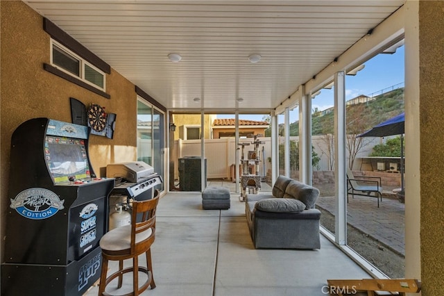 sunroom / solarium featuring a mountain view