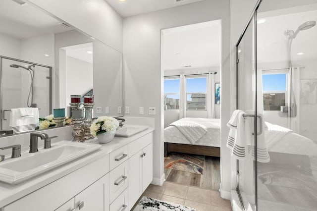 bathroom with plenty of natural light, an enclosed shower, and tile patterned flooring