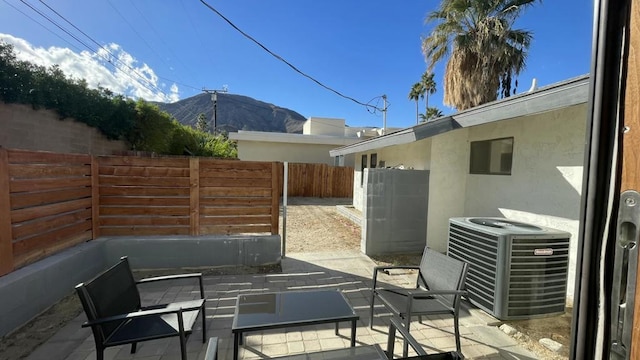 view of patio / terrace with central AC and a mountain view