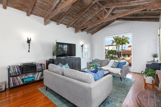 living room with lofted ceiling with beams, hardwood / wood-style floors, and wooden ceiling