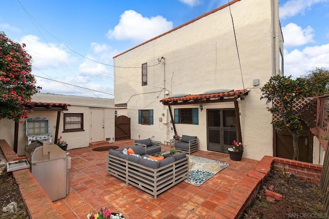 back of house with an outdoor hangout area, exterior kitchen, and a patio