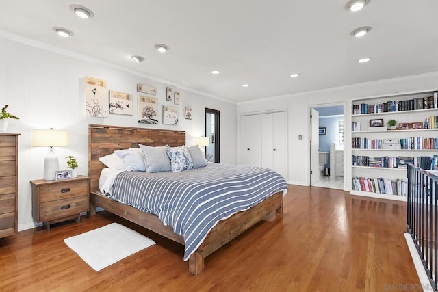 bedroom with hardwood / wood-style floors and ornamental molding