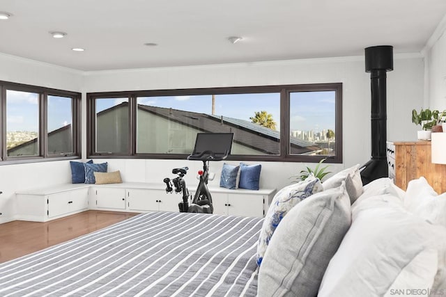 bedroom with crown molding and multiple windows