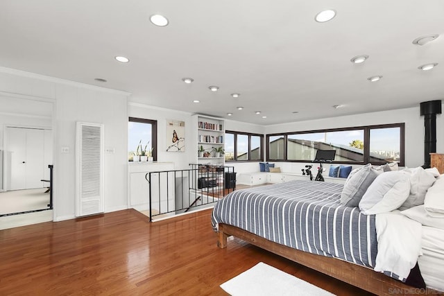 bedroom featuring crown molding and hardwood / wood-style flooring