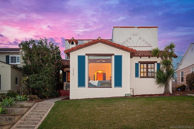 mediterranean / spanish-style house featuring a lawn