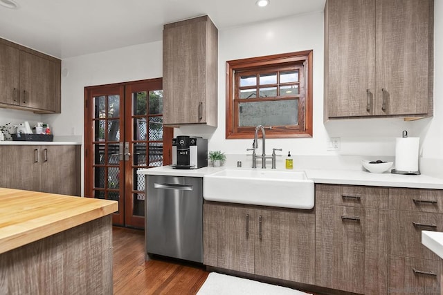 kitchen with dishwasher, sink, a wealth of natural light, and dark hardwood / wood-style flooring