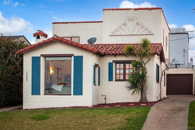 view of front of property with a garage and a front lawn