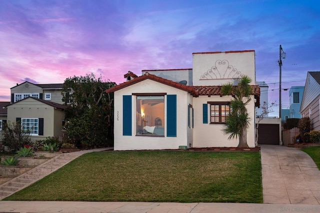 mediterranean / spanish-style home featuring a lawn