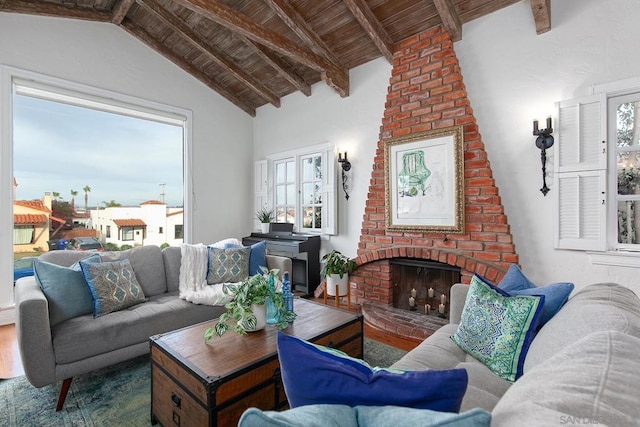 living room featuring vaulted ceiling with beams, wood-type flooring, a fireplace, and wooden ceiling