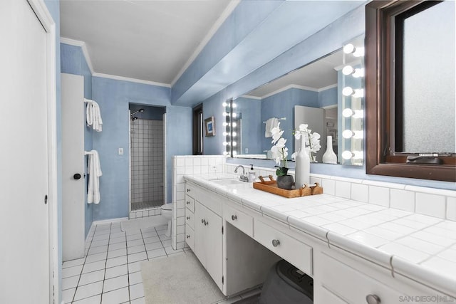 bathroom with vanity, tile patterned flooring, crown molding, and a shower