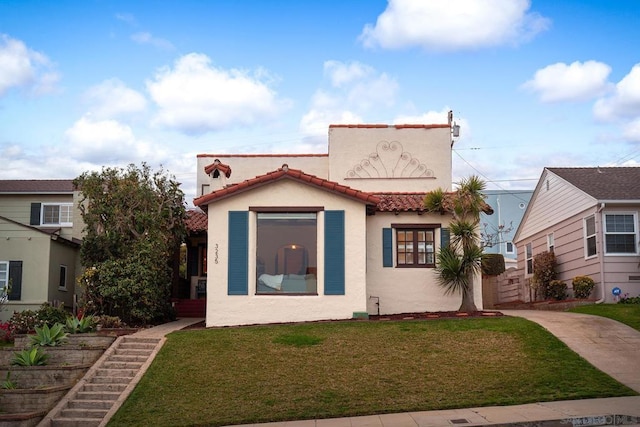 mediterranean / spanish-style home with a front yard