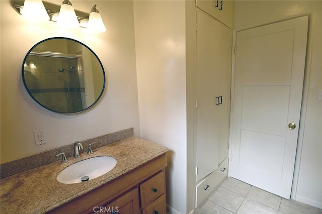 bathroom featuring vanity, tile patterned flooring, and a shower