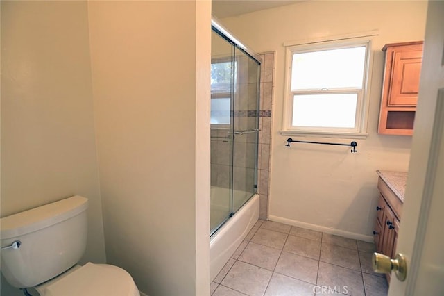 full bathroom with vanity, tile patterned floors, combined bath / shower with glass door, and toilet