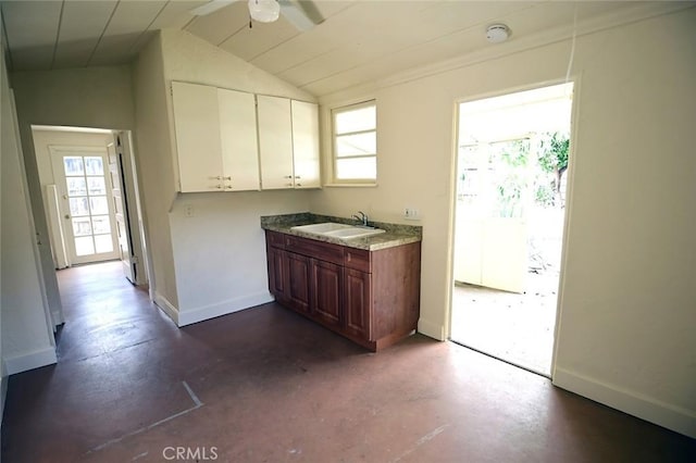 kitchen featuring white cabinetry, vaulted ceiling, sink, and ceiling fan