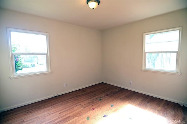 spare room featuring dark hardwood / wood-style floors