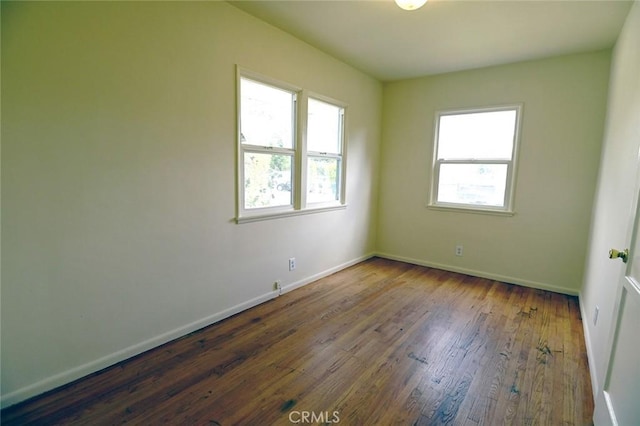 empty room featuring dark wood-type flooring