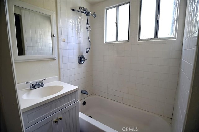 bathroom featuring vanity and tiled shower / bath combo