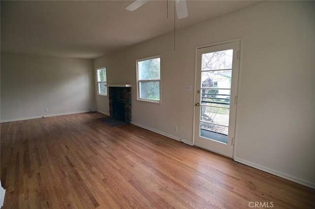 unfurnished living room with wood-type flooring and ceiling fan