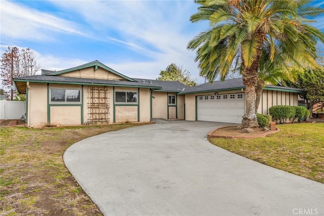 single story home with a garage and a front yard