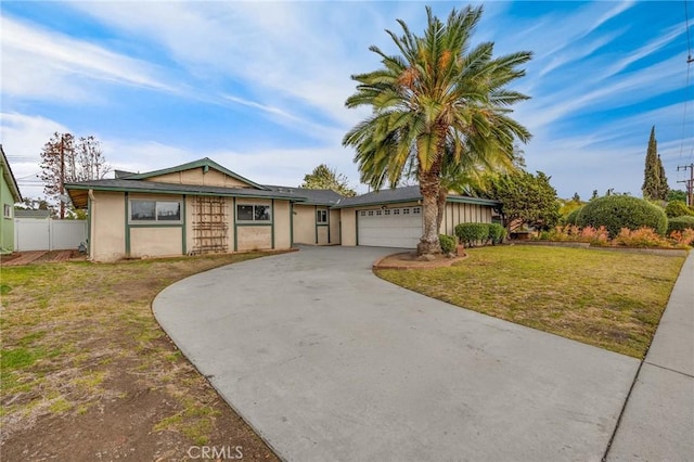 ranch-style home with a garage and a front yard