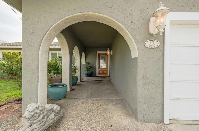 view of exterior entry featuring a garage