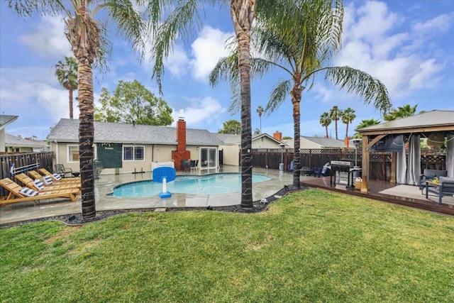 view of pool with a yard, a gazebo, a patio area, and grilling area